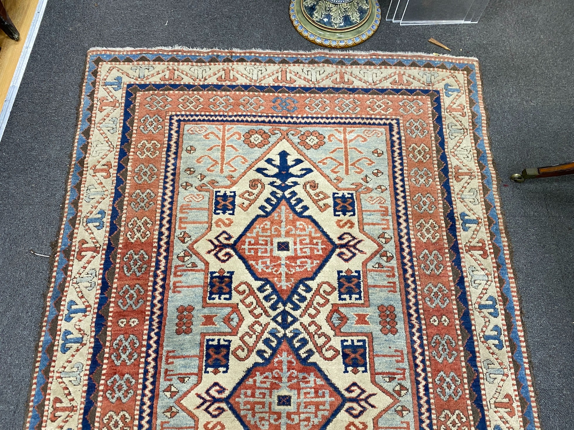 A Caucasian style ivory ground rug, 188 x 133cm